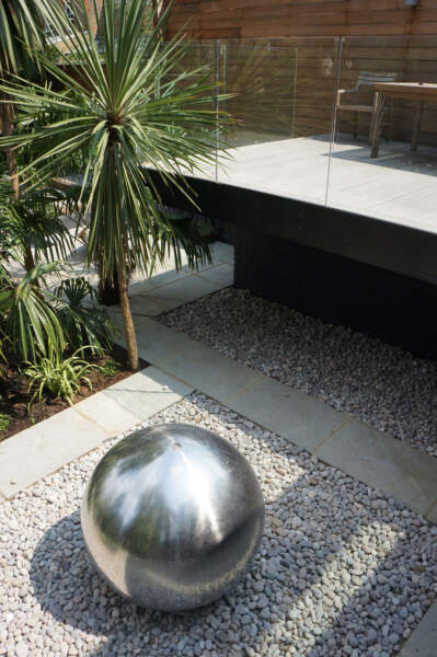 Hard landscaping garden design, cantilevered extension, beautiful gardens, steel sculpture