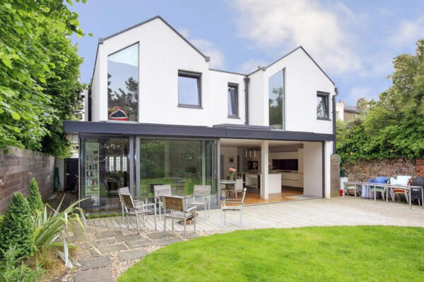 New Build house in Twickenham, with glass skylight on the ridge of the roof bringing daylight two floors down into the entrance hall.