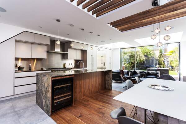 Kitchen extension to a roundhouse kitchen with timber flooring and glass skylights in Waldegrave Gardens, London.