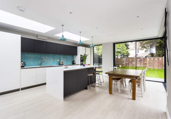 lovely, crisp, contemporary kitchen green glass splashback grey units