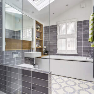 Bathroom and shower room with vaulted ceiling and an electric skylight