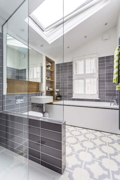 Bathroom and shower room with vaulted ceiling and an electric skylight